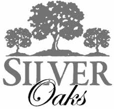 Logo of Silver Oaks featuring three stylized trees above the text, with Silver in bold and Oaks in a cursive font.