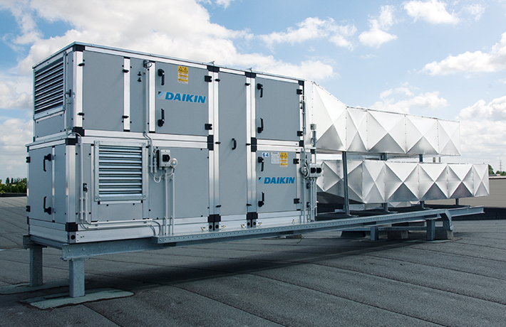Rooftop view featuring a sizable air conditioning unit, essential for climate control in the structure.